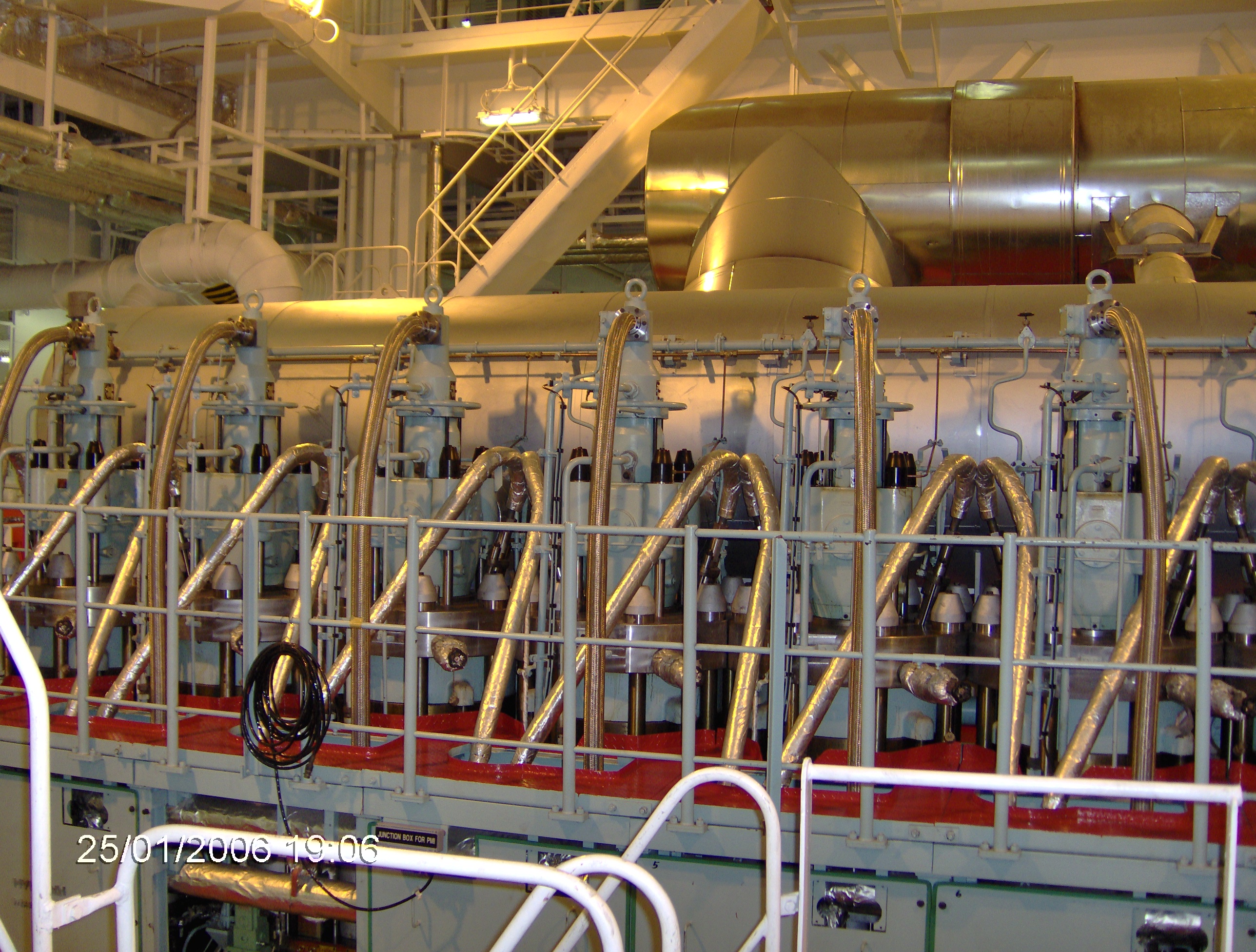 Metal piping, equipment, and engineered systems inside a ship engine room