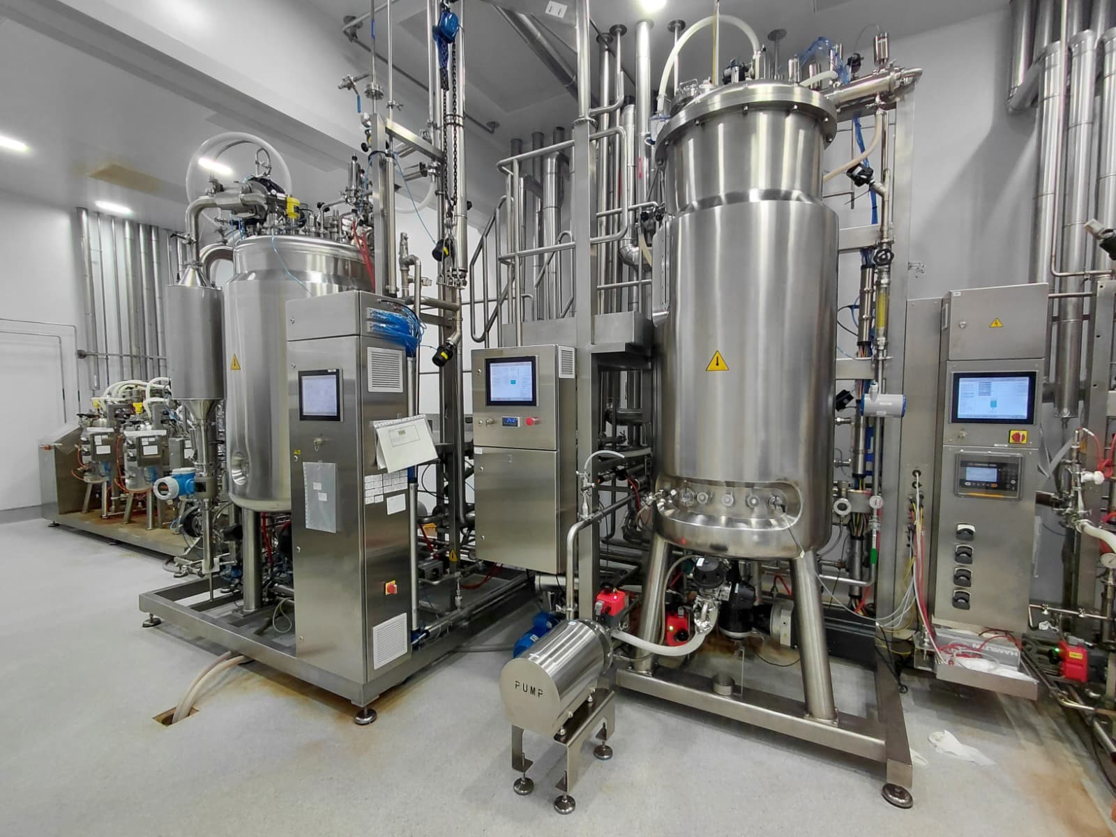 Stainless steel bioreactor, sanitary tubing, and pump equipment in a medical process facility